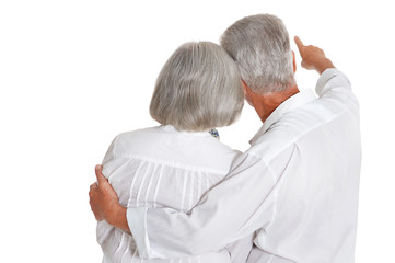 rear view of senior couple hugging on white background