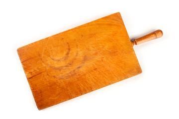 A photo of an old wooden cutting board, shot from the top on a white background with a place for text. A cooking frame with copy space