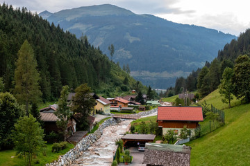 Village in the Alpine valley near the river. Austria