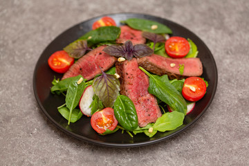 Roast Beef Salad with Green Mix. Thick Slices of Juicy Medium Rare Veal. Delicious gourmet beef salad