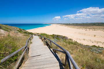 Fototapeta na wymiar wooden ramp with railing down to the beach in Cape Trafalgar, also known as Zahora or Cala Isabel, in Barbate, Cadiz, Andalusia, Spain