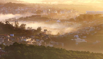 Fantastic foggy village in the sunlight in Dalat, Vietnam