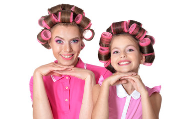 Mother and little daughter in hair curlers