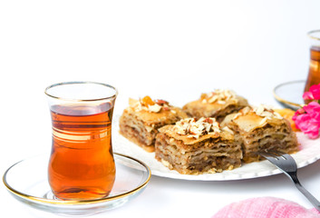 Baklava and turkish tea on white background