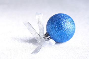 Christmas or holiday composition with blue silver balls on billowy feathers with snow and snowflakes.