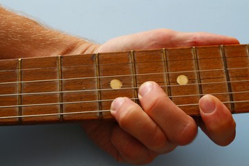 Guitar strings on the fretboard