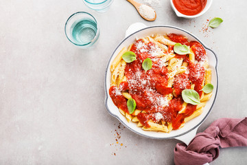 Tomato italian penne pasta served in pan