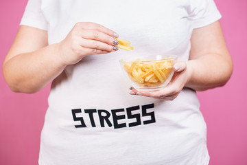 stress, eating problems, bulimia, compulsive overeating, weight gain. overweight woman with portion...