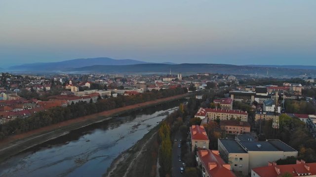 Aerial view of middle class houses in small village or town in the countryside. over the Uzh River Top view above houses at sunrise above in the autumn Uzhhorod Ukraine Europe
