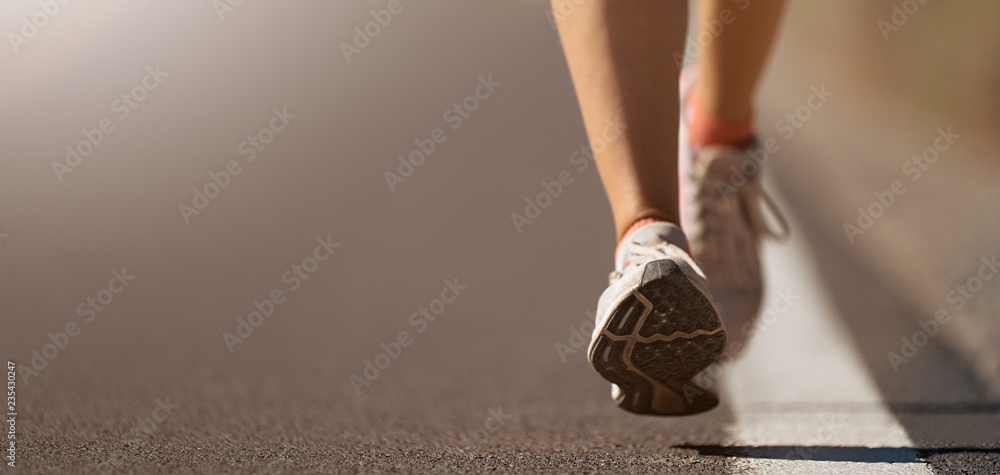 Poster running shoe closeup of woman running on road with sports shoes