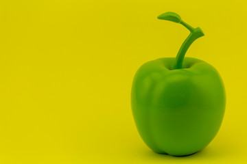 green Apple on yellow background