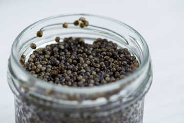 Russian black caviar in the glass jar, closeup