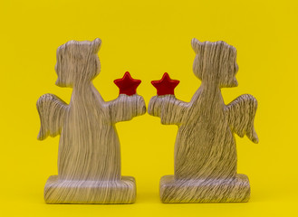 figures of angels with hearts on a yellow background. decorate the house