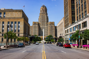 Fototapeta na wymiar Buffalo City hall and Niagara Square ( State of New York) view from court Street during day time from the middle of the road. Blue sky with almost no clouds and no cars driving by.
