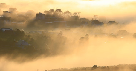 Fototapeta premium Fantastic foggy village in the sunlight in Dalat, Vietnam
