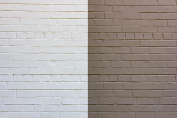 White and brown separated in half wall brick background