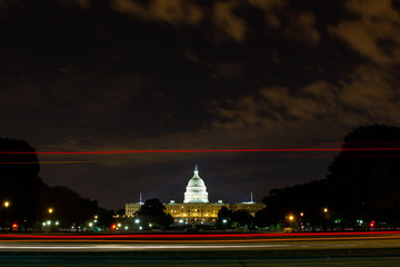 United States Capitol in Washington DC by night with a long exposure and traces of lights from the car passing by.