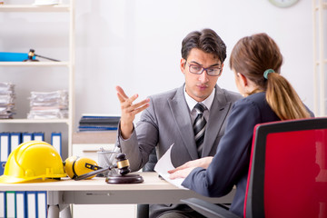 Lawyer talking to client in office