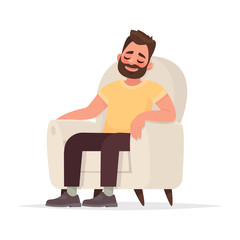 Bearded man sits in an armchair and sleeps. A person is resting or thinking about something good