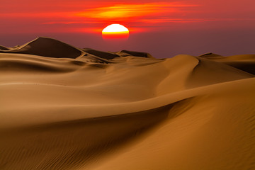 Beautiful desert landscape with a colorful sunset. Sunset sun.