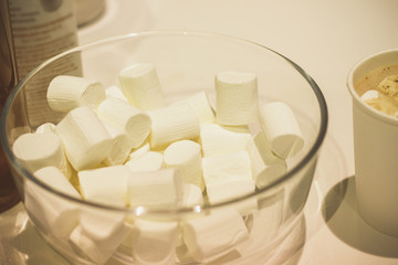 Glass bowl with white marshmallow.