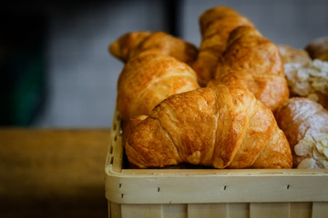 Close-up of fresh croissants, powdered sugar and puffs.