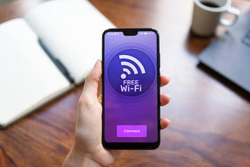 Free wifi connection on mobile phone screen. Internet and telecommunication technology concept.