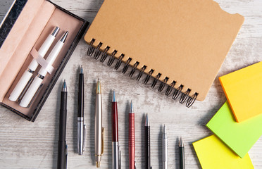 notebook and pen in wooden background