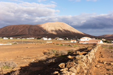 Landscape with cloudy sky in the region of La Oliva. Fuerteventura, Canary Islands, Spain