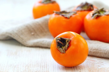 Ripe persimmon fruit on wooden table ready for eat