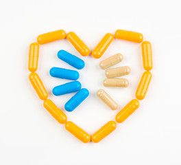 The symbol of the heart from drug capsules on a white background. The concept of health and medicine.
