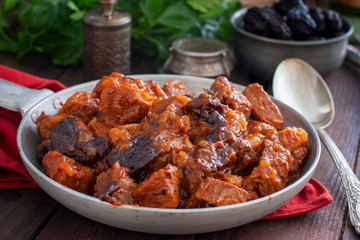 Beef with prunes in tomato sauce in a pan, horizontal
