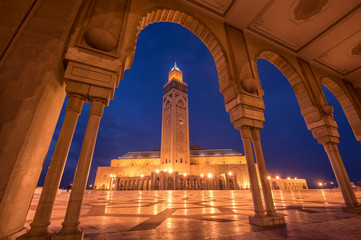 Fototapeta na wymiar The Hassan II Mosque at the night in Casablanca, Morocco. Hassan II Mosque is the largest mosque in Morocco and one of the most beautiful. the 13th largest in the world. Shot after sunset at blue hour