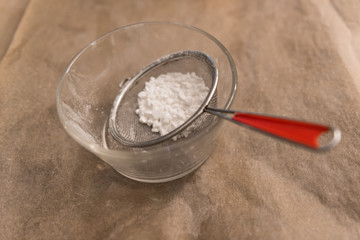 powdered sugar in a strainer