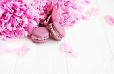 Pink peony flowers with macarons