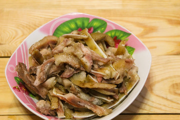 Boiled fragrant pork ears in plates on a wooden table