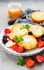 Delicious pancakes with berries on a concrete backrgound