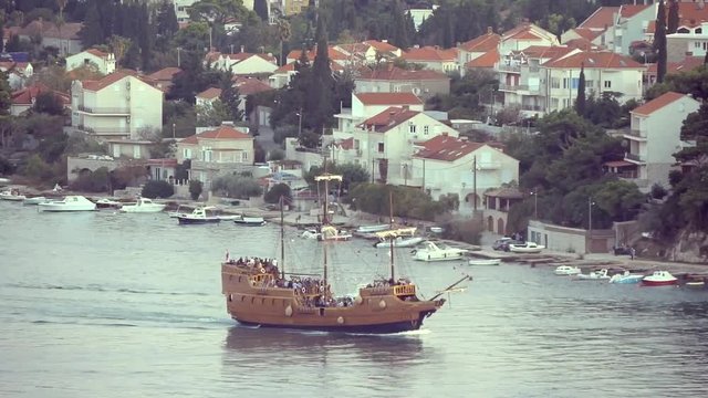 Replica Of Historic Sailing Ship With Tourists Passes Along The Quay