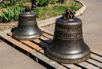 Obraz premium Two bells on the territory of the Orthodox Church of St. Nicholas, prepared for installation on the bell tower.