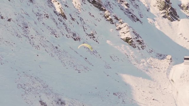 paragliding in winter. Paraglider on the background of mountains