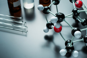 molecular formula and laboratory equipment on a blue background. Science organic chemistry concept
