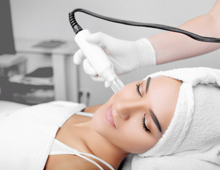 woman receiving no-needle high frequency mesotherapy at beauty salon. non-invasive procedure for...