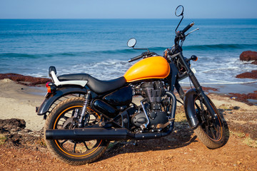 motorcycle royal enfield on a background of tropical paradise sea and rock.travel and entertainment...