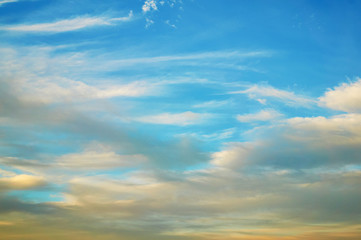 Wavy, porous curly clouds in the blue sky. Nature Background.