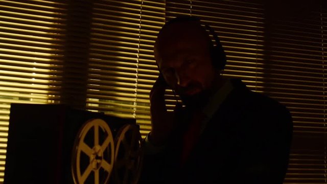 Special agent scout listens to conversations and makes a record on the tape3