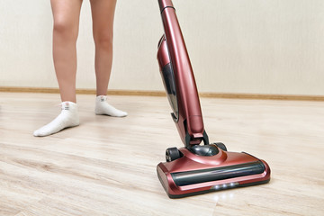 Cleaning lady vacuums with  upright vacuum cleaner.
