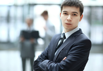 close up.confident young businessman on blurred office background