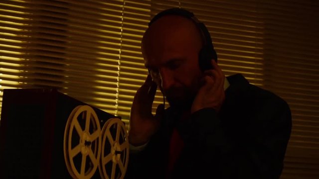 Special agent scout listens to conversations and makes a record on the tape