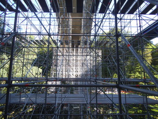 A grey iron skeleton below a very high bridge in Luxembourg.