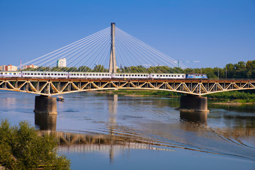 Fototapeta na wymiar Warsaw, Poland - Panoramic view of the Vistula river with Most Srednicowy railway bridge and northern district of Warsaw